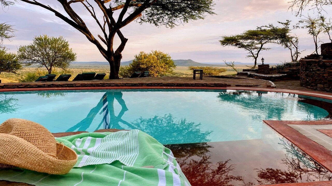 Quick drying towel in pool setting overlooking African landscape