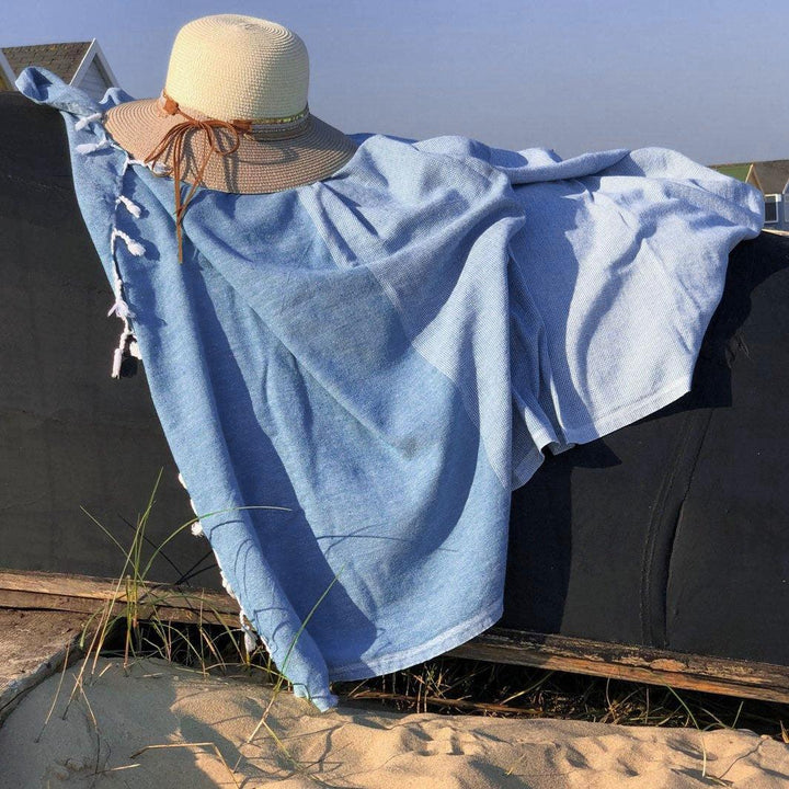 Denim blue quick drying towel draped over an upturned boat.