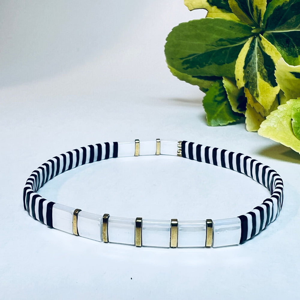 White, gold and black bracelet.