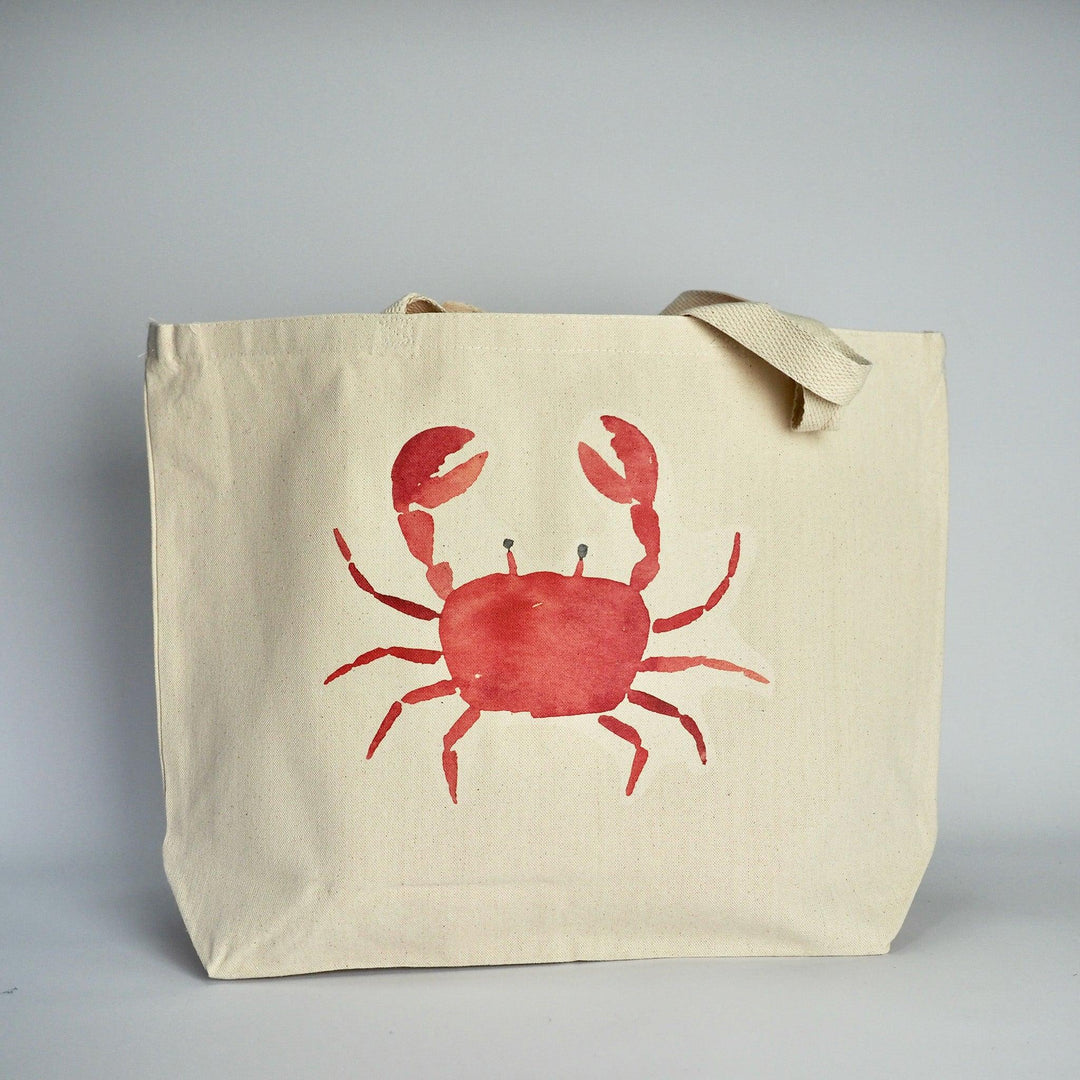 XL Canvas Tote Bag with a fun crab print design on front in coral and with handles folded over.