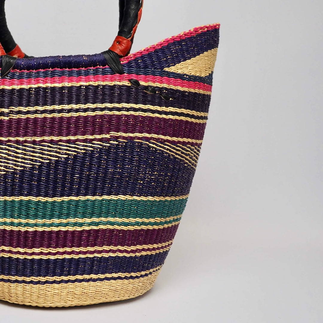 close up of Shopper basket with leather handles in multicoloured design.