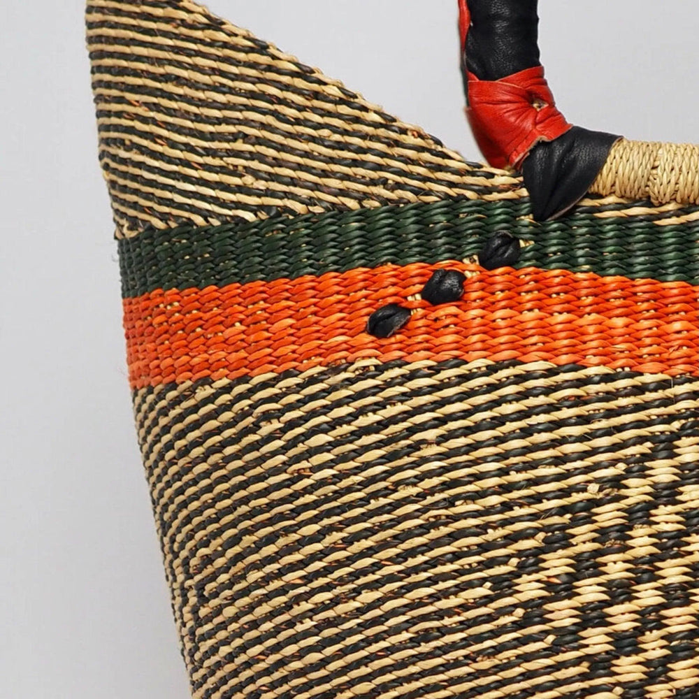 Close up of Orange and green african basket, large with leather handles