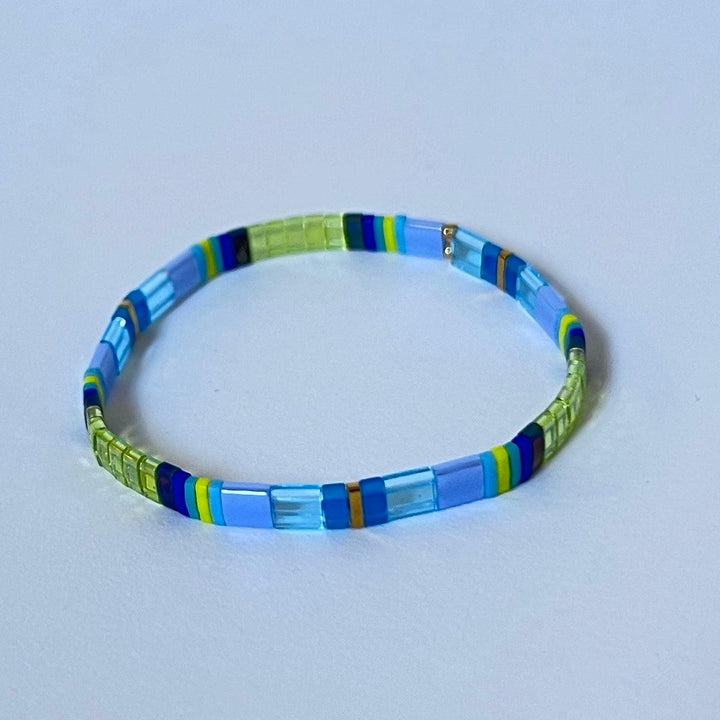 Product image of tila bead bracelet in blues and green beads.