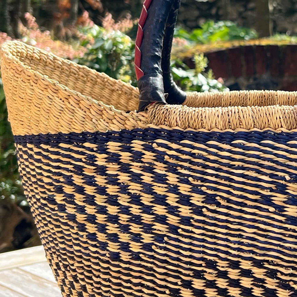 Close up of woven blue and black african basket.