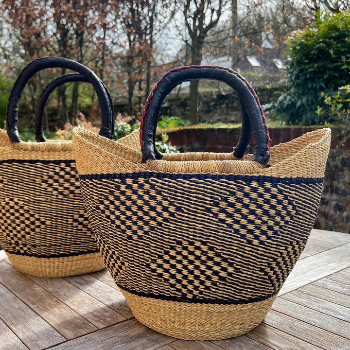 Two blue and neutral tone baskets in garden setting