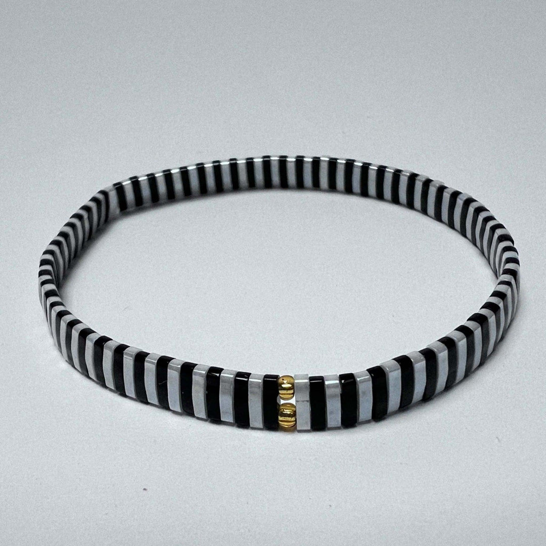 Product image of a tila bead bracelet in black and white tile beads.