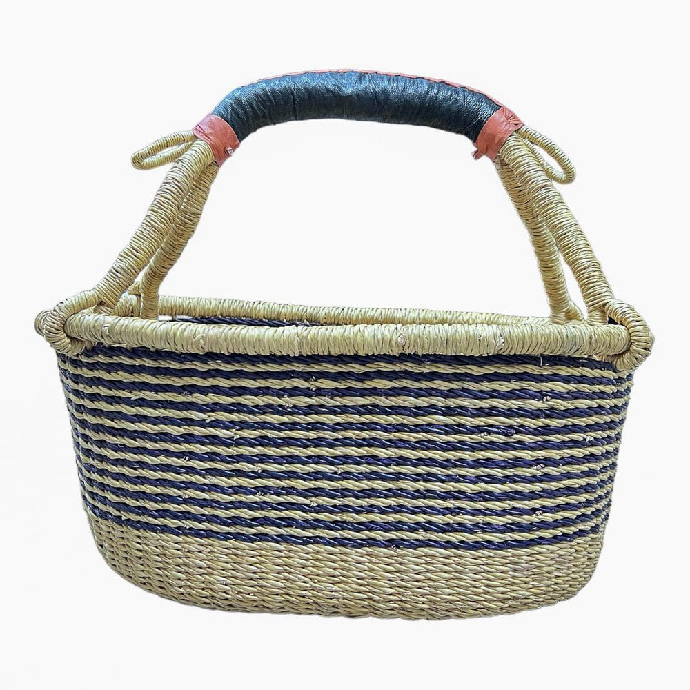 Handwoven basket, oblong in shape, blue and with leather handles against a plain background. 