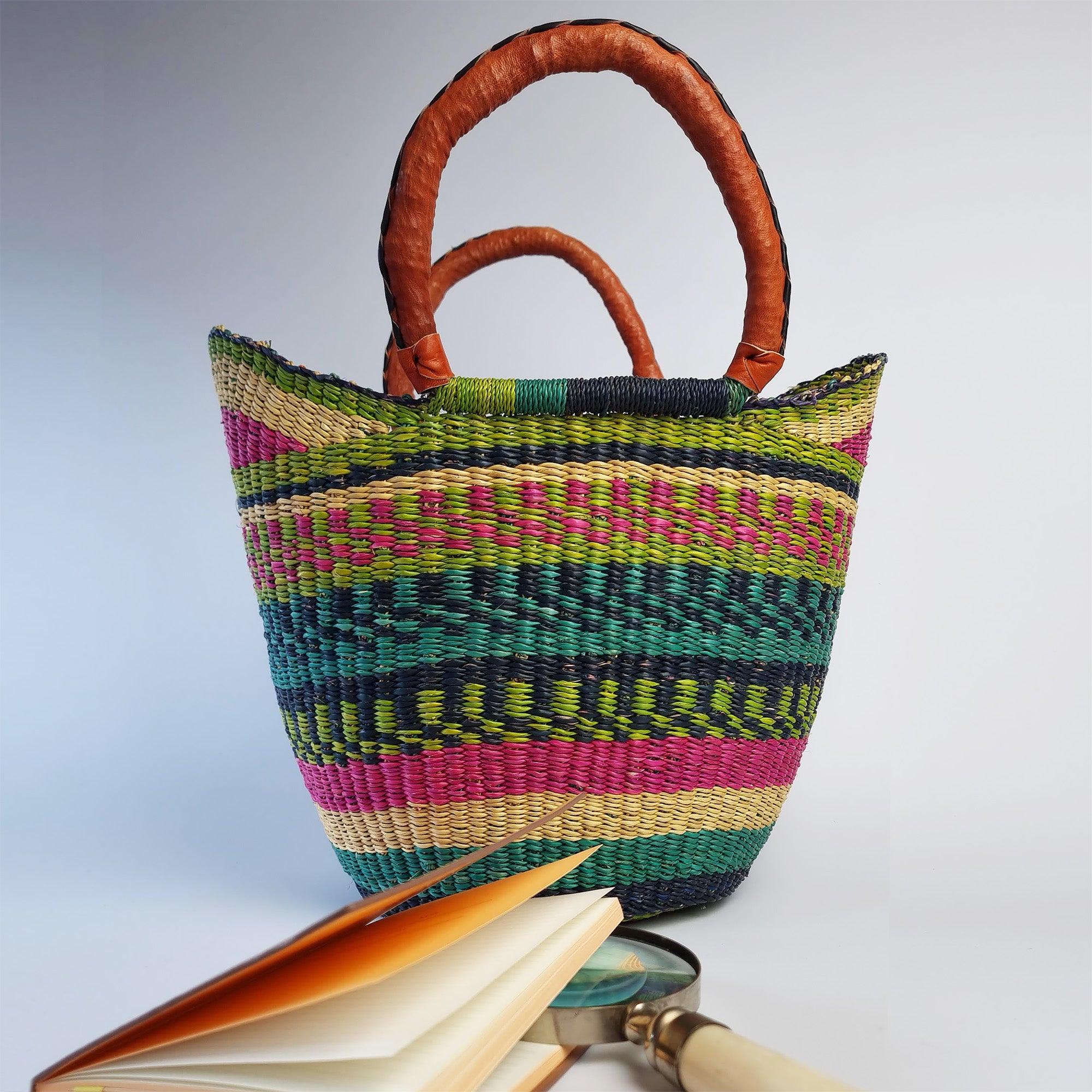 African Shopper Basket in the background with a notebook and magnifying glass in the foreground to show the scale.