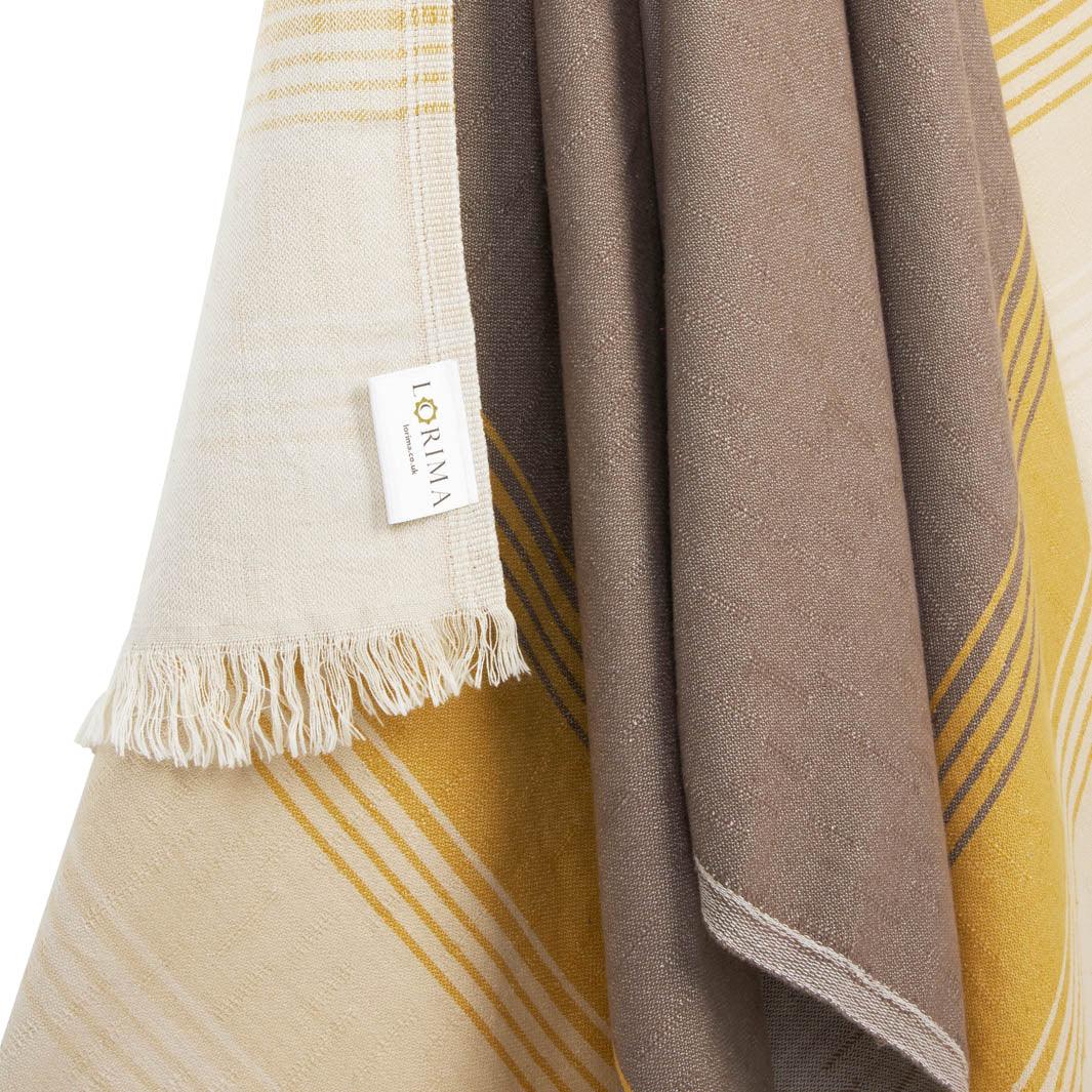 Close up of Fiesta hammam towel in earthy tones of taupe and mustard.
