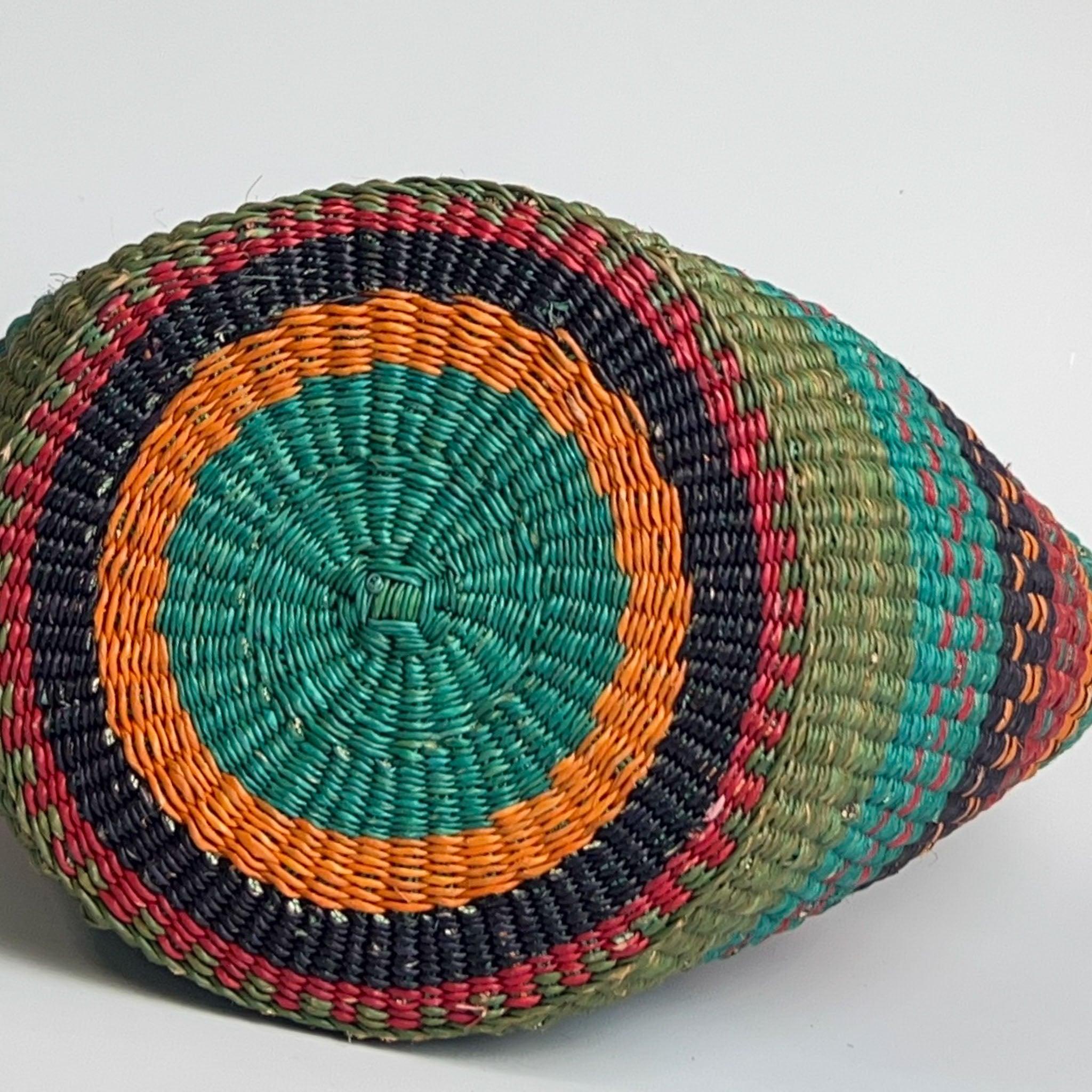 Base of attractive traditional African basket showing off a colourful design of blue, orange and teal.