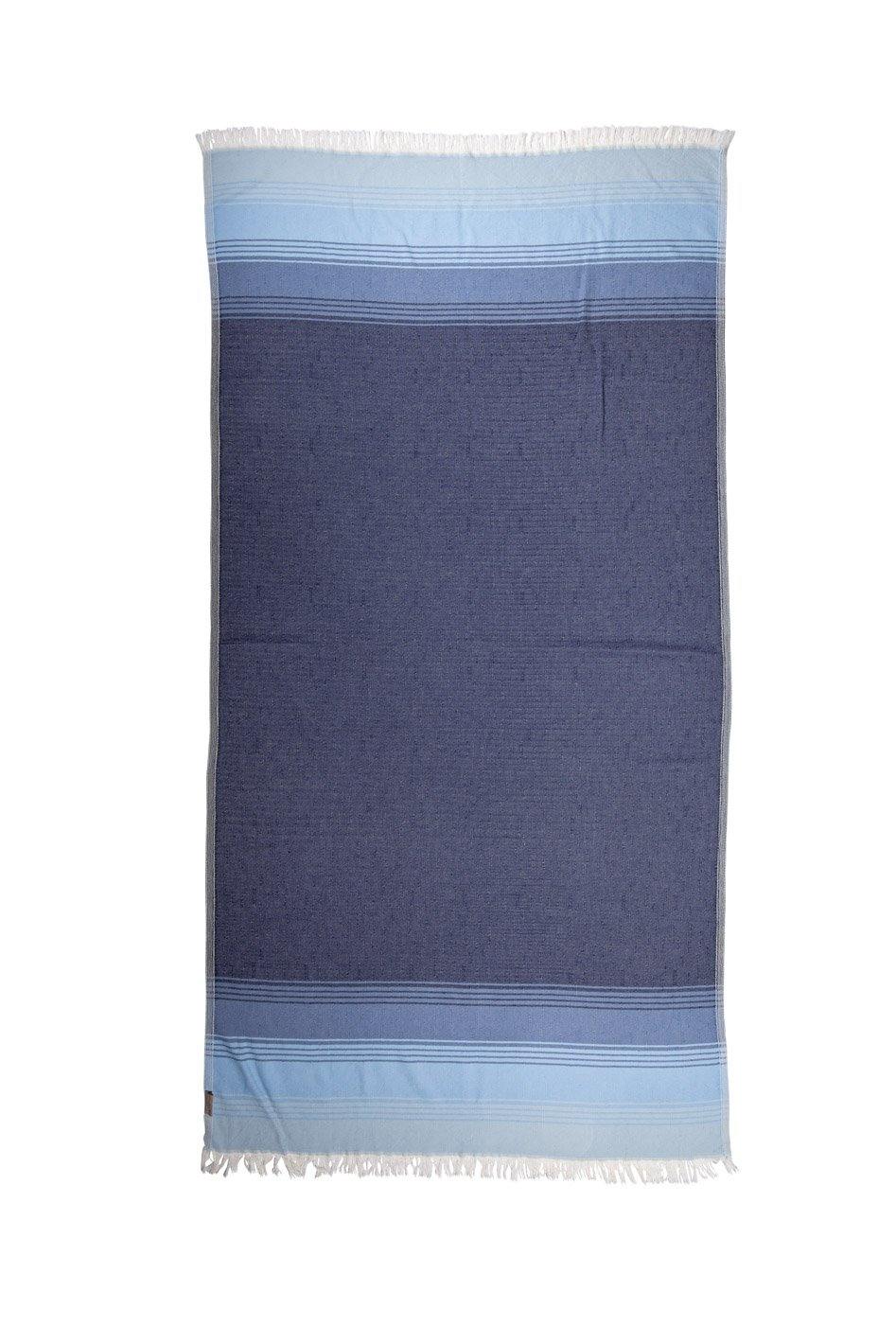 Ocean blue inspired tones make up this lightweight beach towel, taken against a white backdrop.