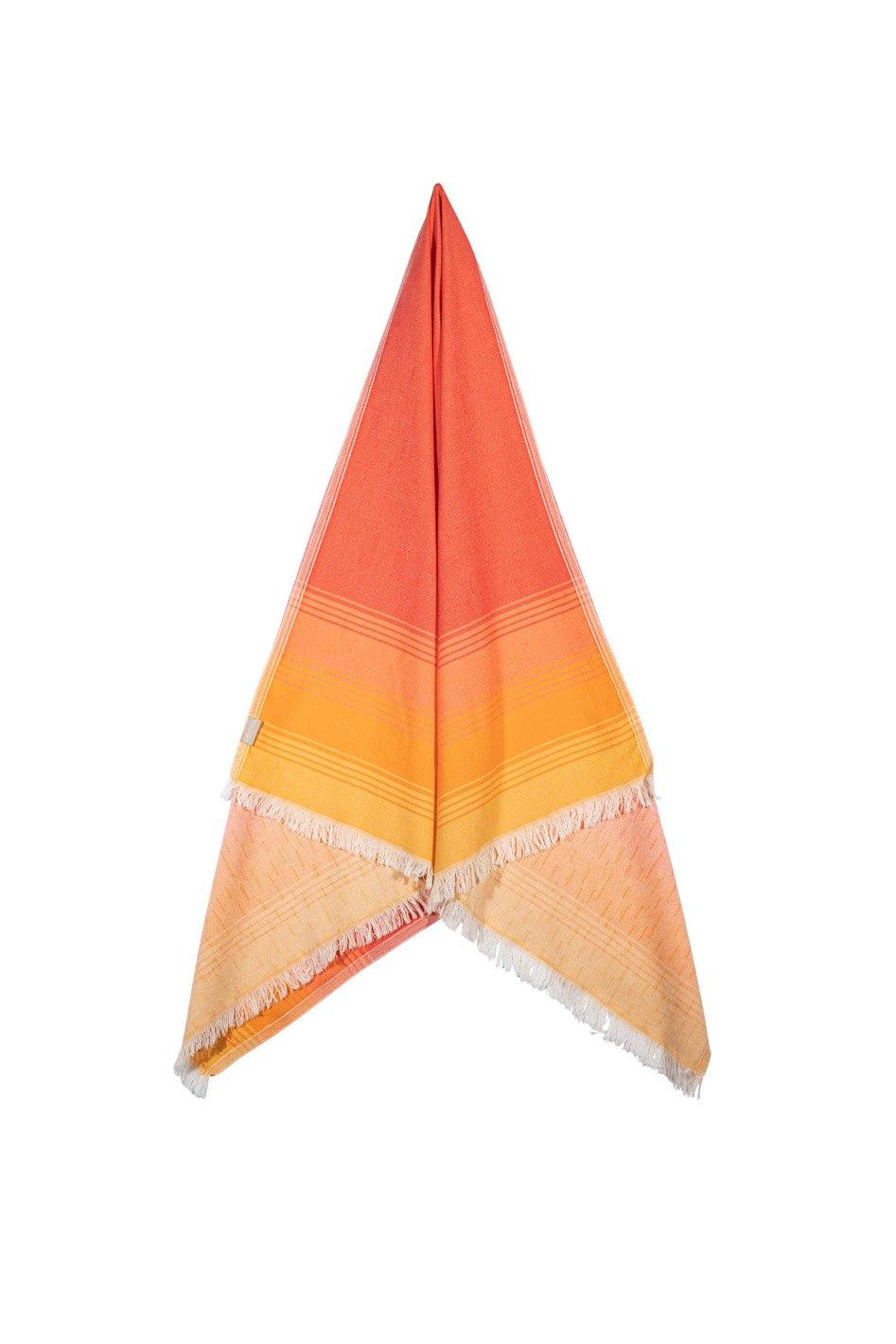 Sunset Beach towel folded, showcasing the colourful and warm orange tones and modern fringed edge.