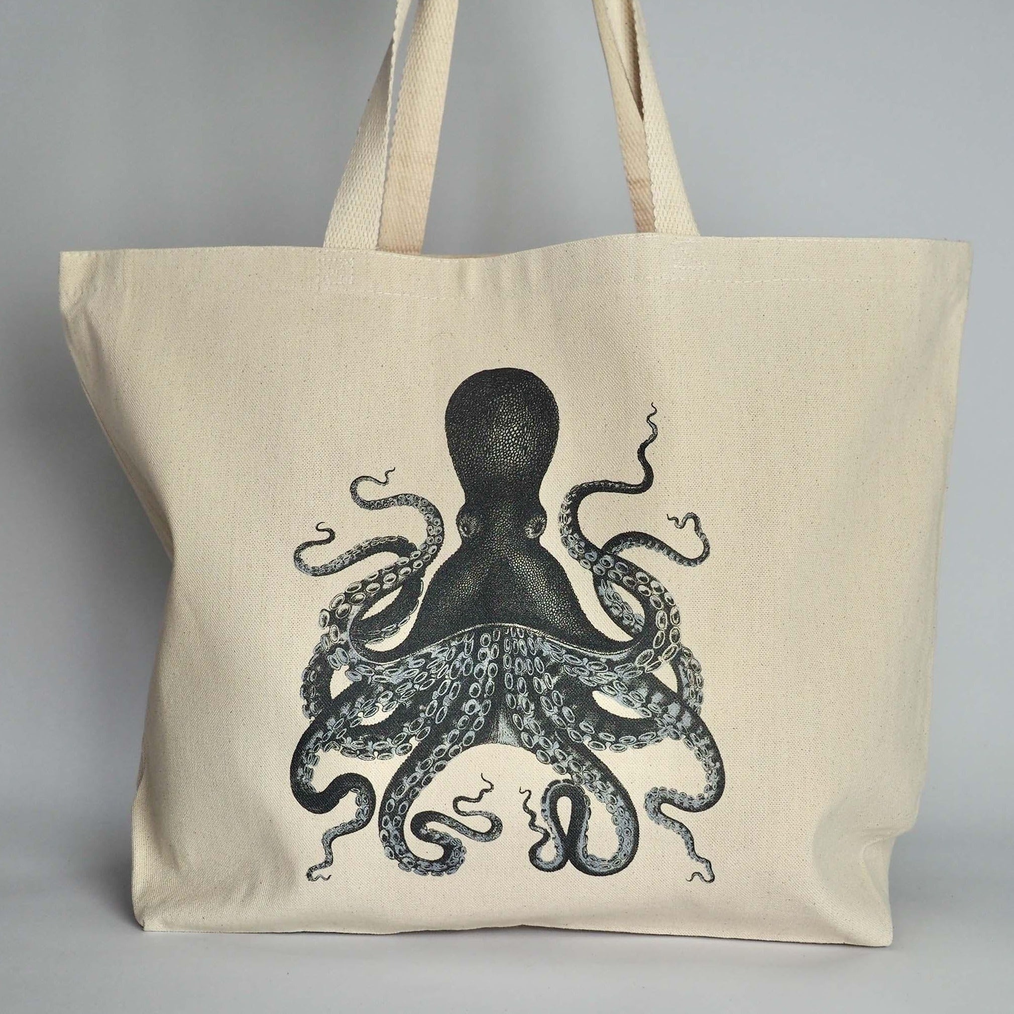 XL Canvas Tote Bag with a fun crab print design on front in coral and with handles folded over.