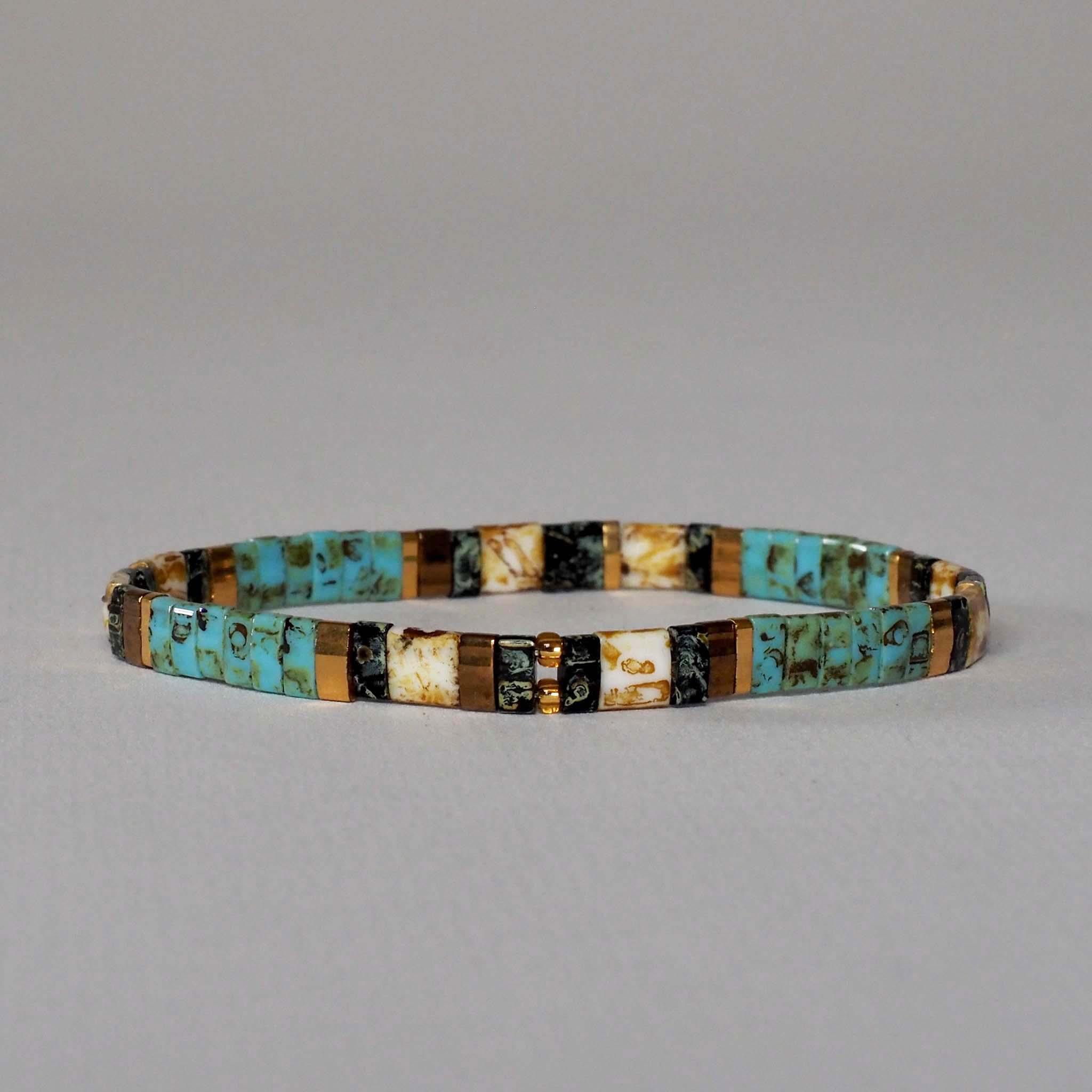 Miyuki Glass Bead bracelet, detailing turquoise mottled design with gold and black and set against a plain background