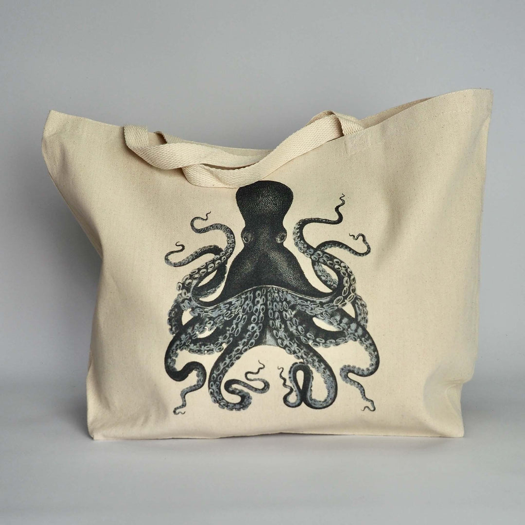 Close-up of XL canvas tote bag with playful ink blue Kraken style octopus design on the front